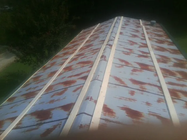 Rusted metal roof panels with new wood purlins before replacement — Storm Damage Roof Repair in Union City by Roofing Brothers